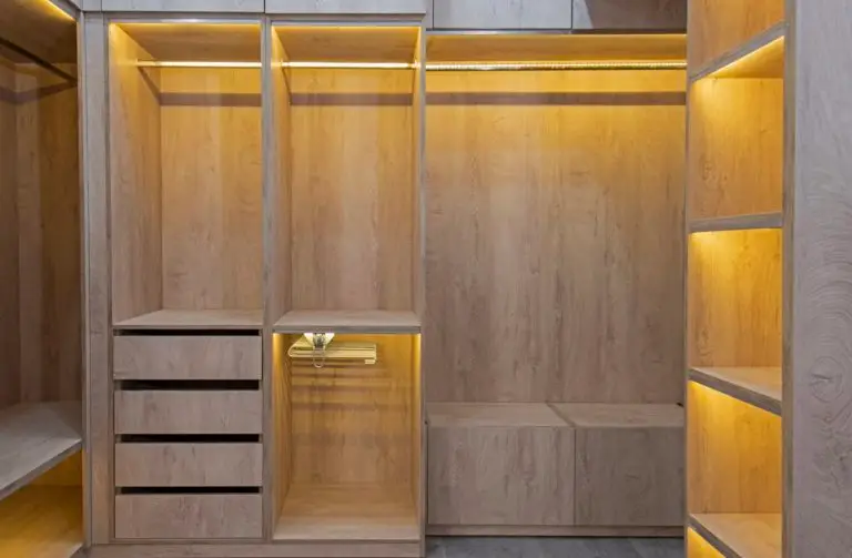 Interior design decor furnishing of luxury show home bedroom showing walk in wooden wardrobe closet furniture