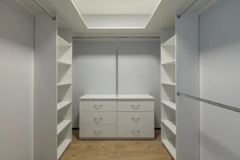 Inside of the empty modern walk-in wardrobe open door