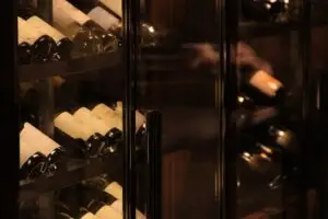 Wine,Bottles,Lying,In,A,Modern,Glass,Cellar